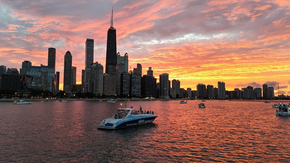 Boats anchored at the Chicago Playpen on Lake Michigan with the city skyline